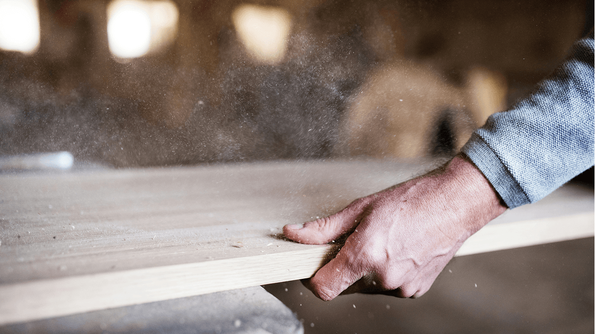 person cutting wood