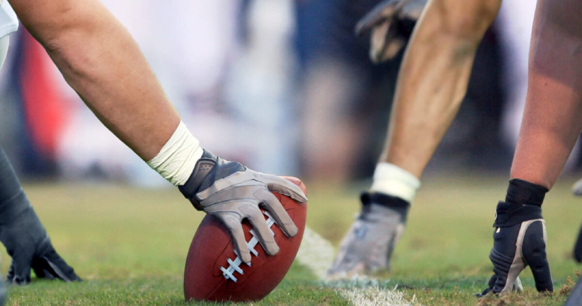 football players waiting got the ball to snap